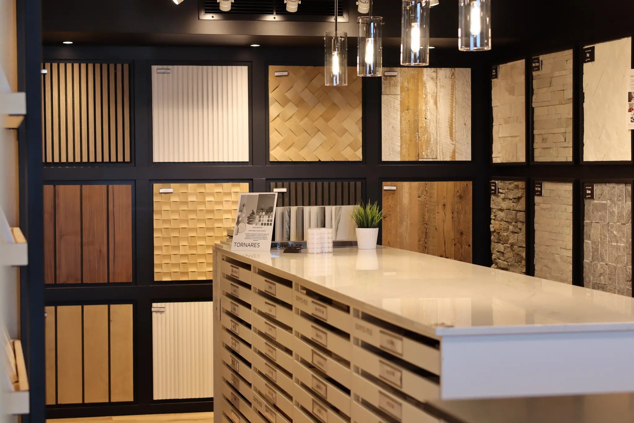 a counter with a variety of wood, quartz and porcelain samples